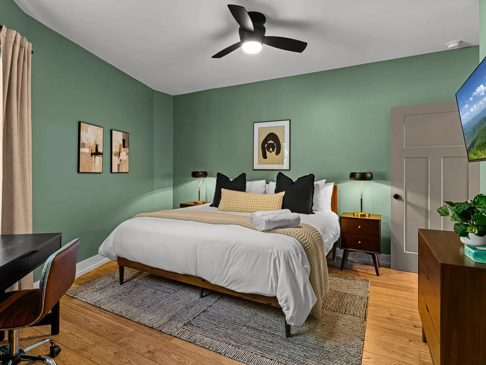 Vacation rental bedroom with sage green walls, styled for Airbnb